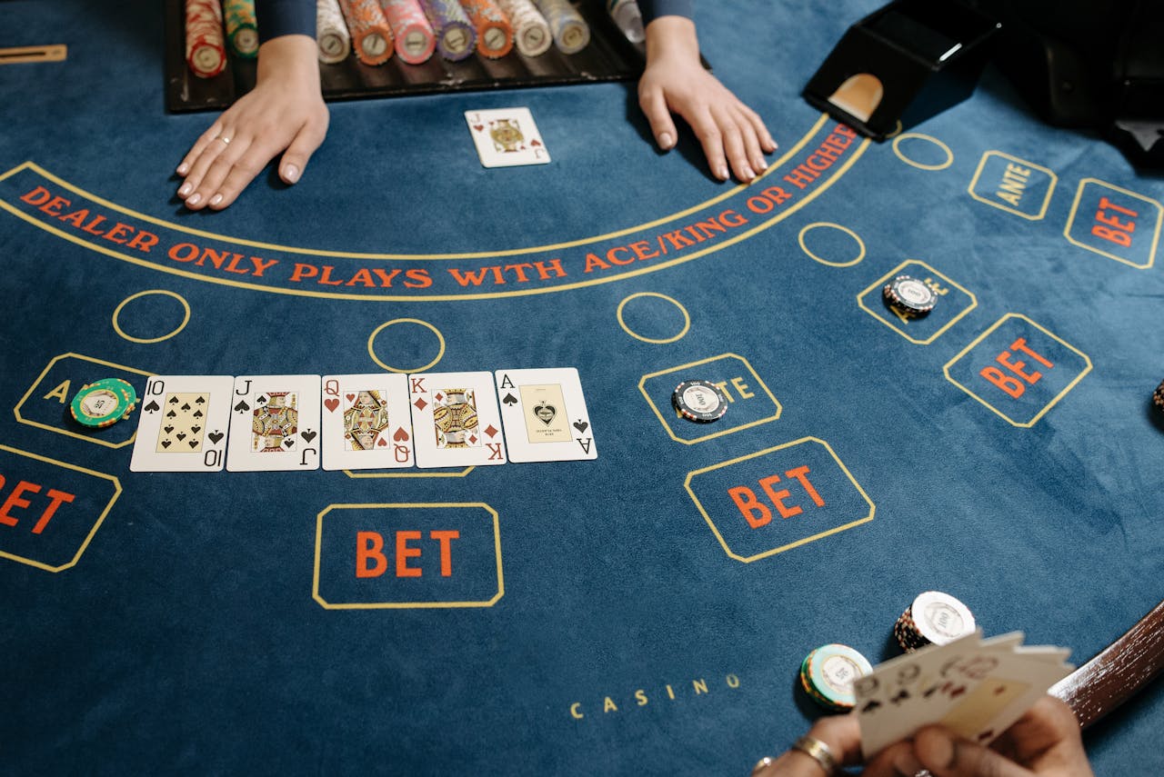 who-we-are A casino gaming table featuring poker cards and chips, showcasing a vibrant gambling scene.